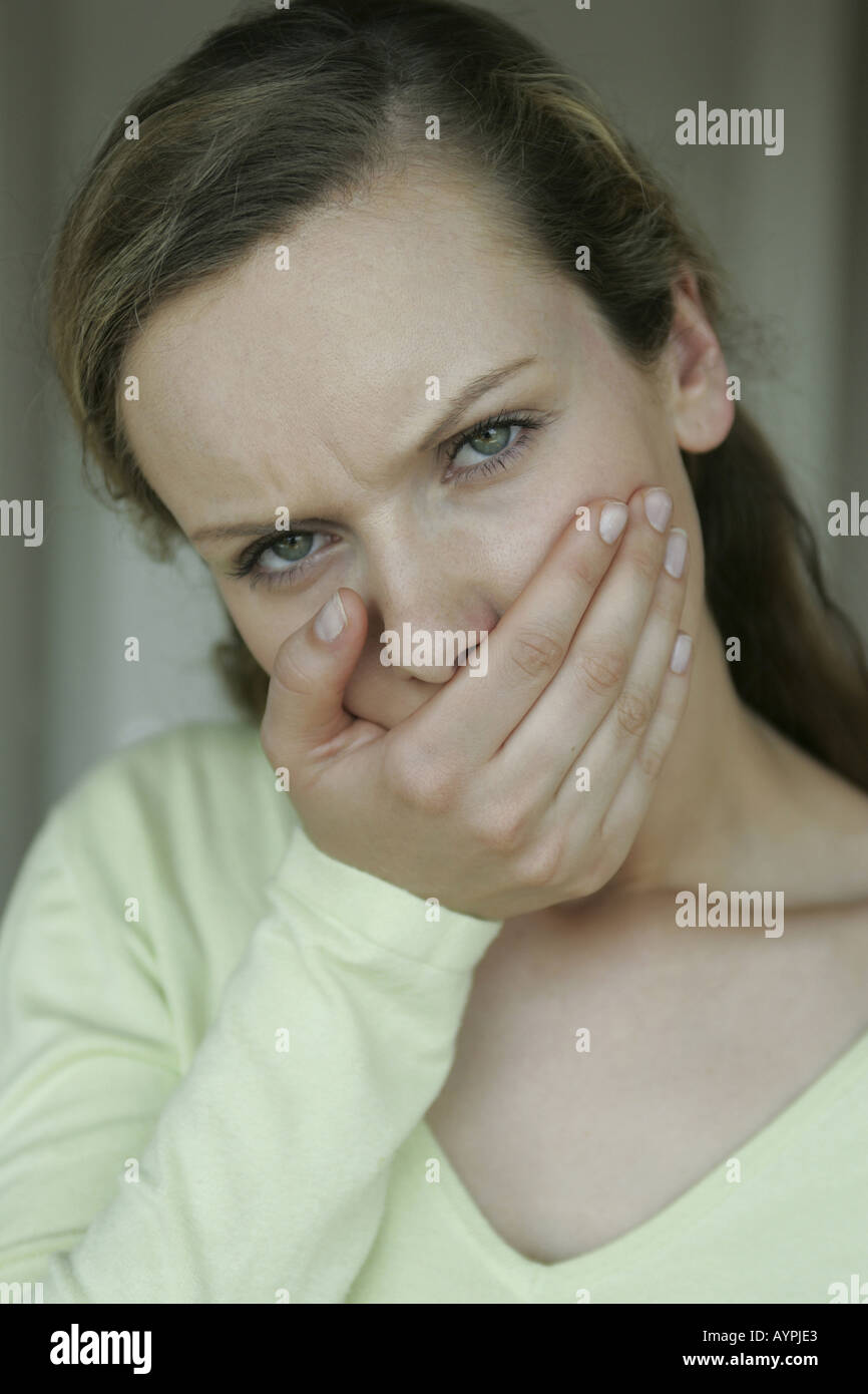 A blonde woman is shocked by looking at something Stock Photo