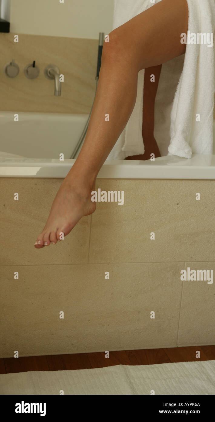 Leg Of A Woman Moving Out Of Her Bathtub Stock Photo