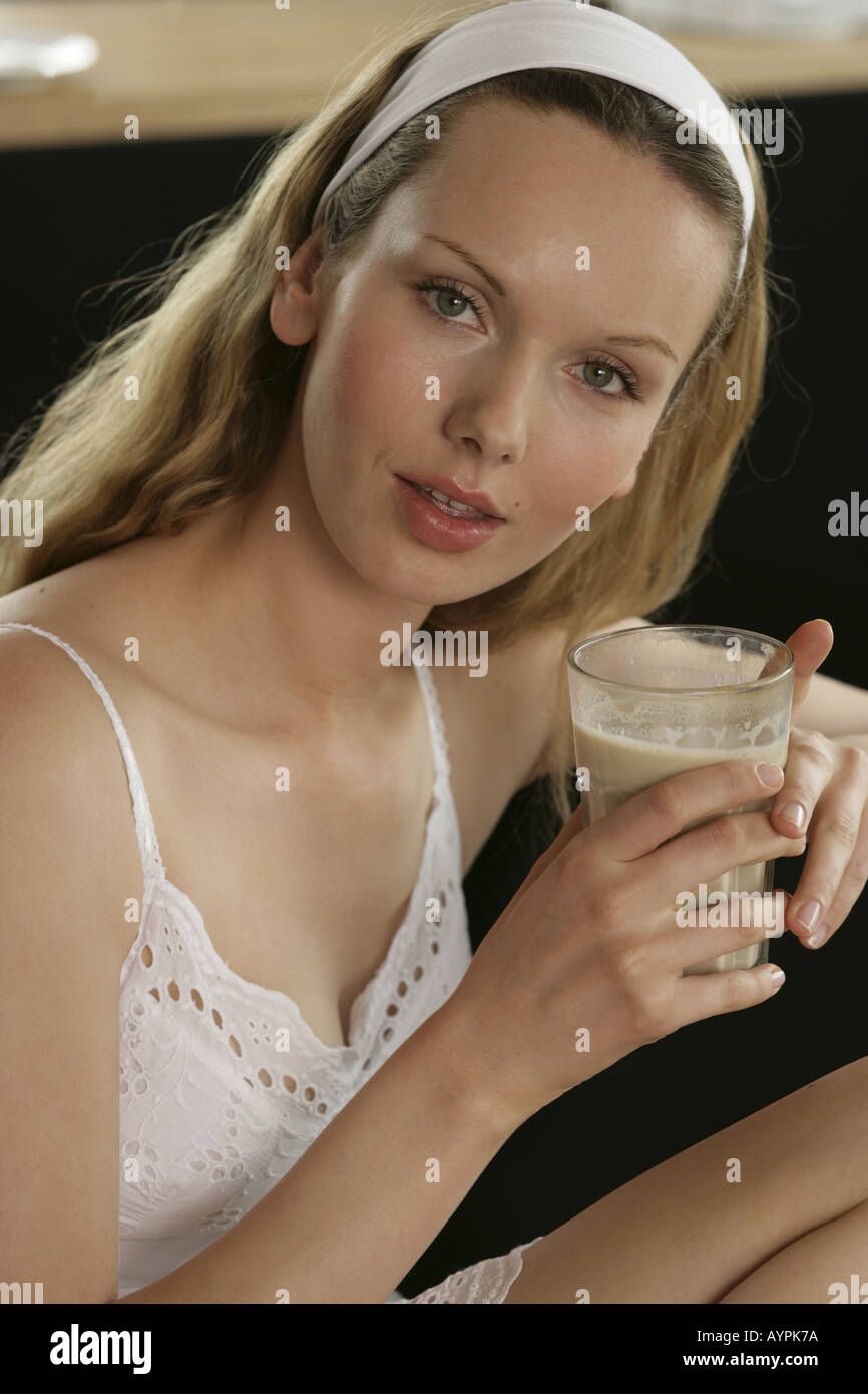 A front view of blonde woman having a glass of coffee Stock Photo