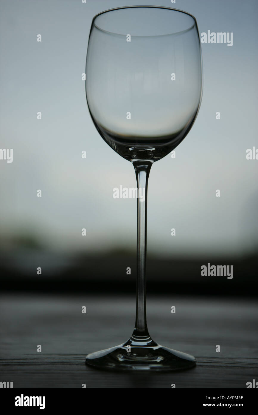 A wine glass kept on a wooden table Stock Photo