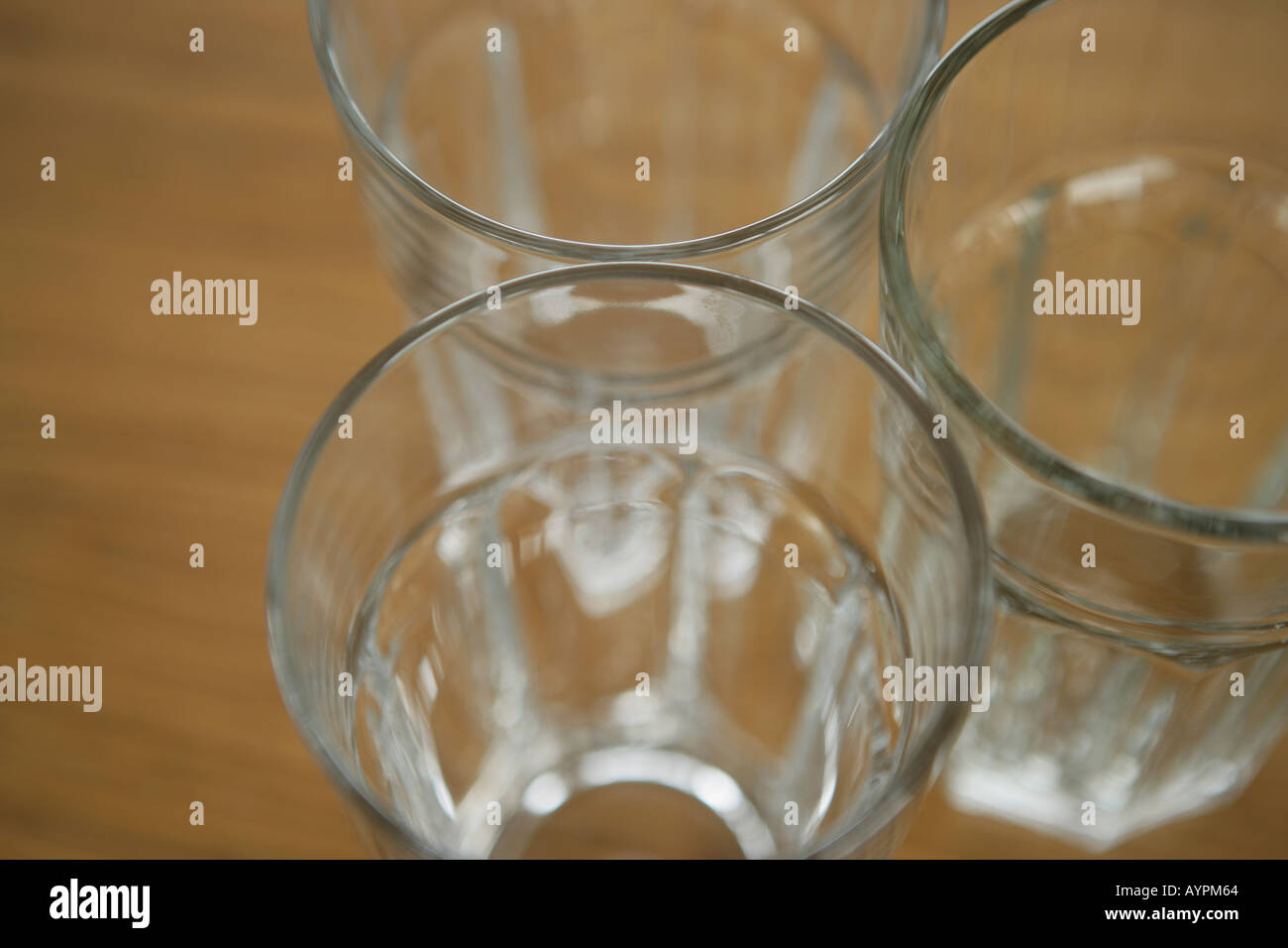 Three empty glasses kept on a table close to each other Stock Photo