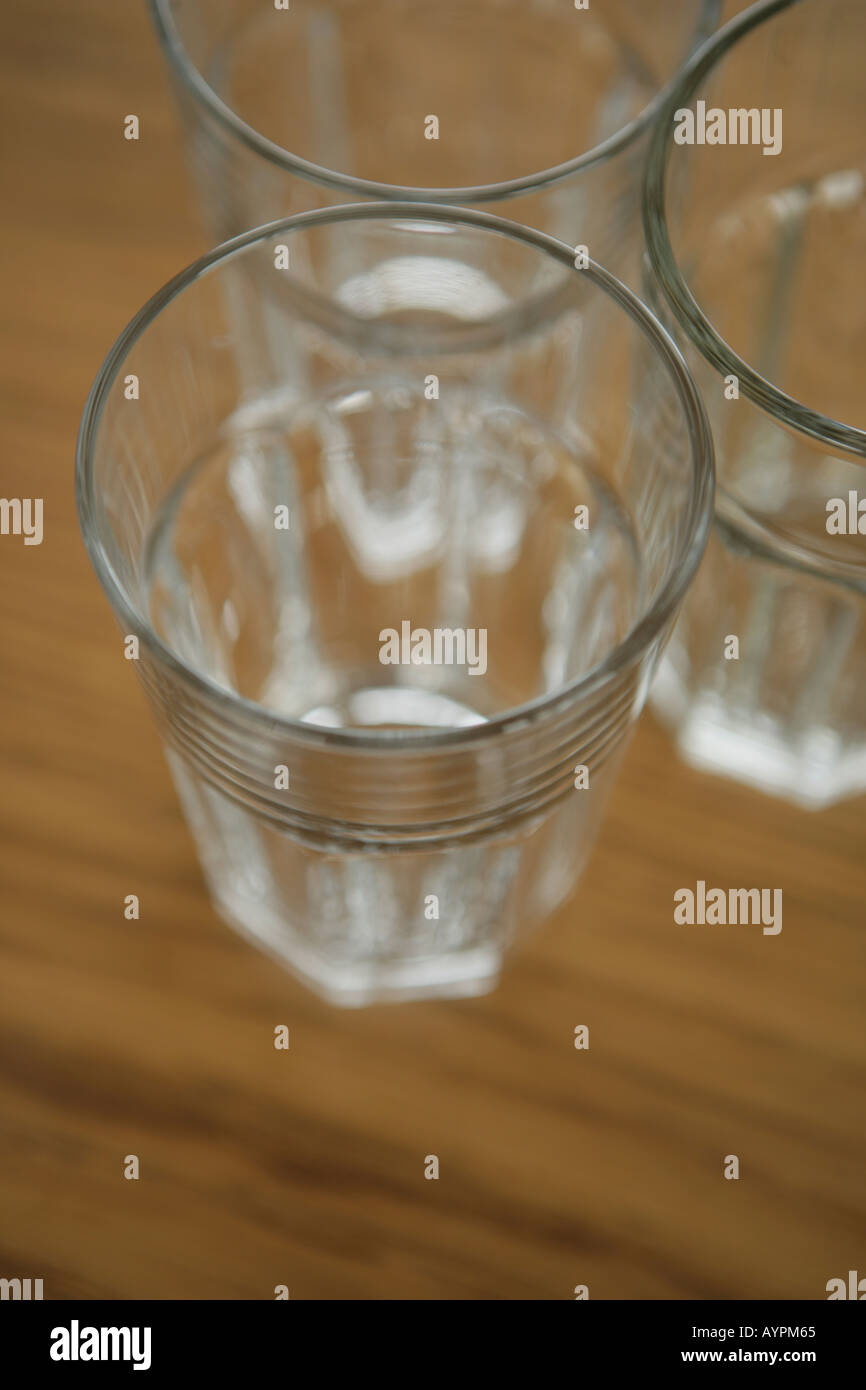 Three empty glasses kept on a table close to each other Stock Photo