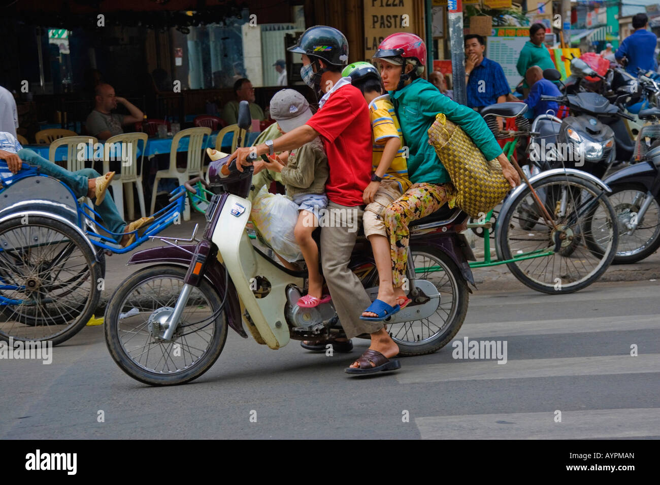 Four people sharing a bike, Ho Chi Minh City (Saigon), Vietnam, Asia Stock Photo