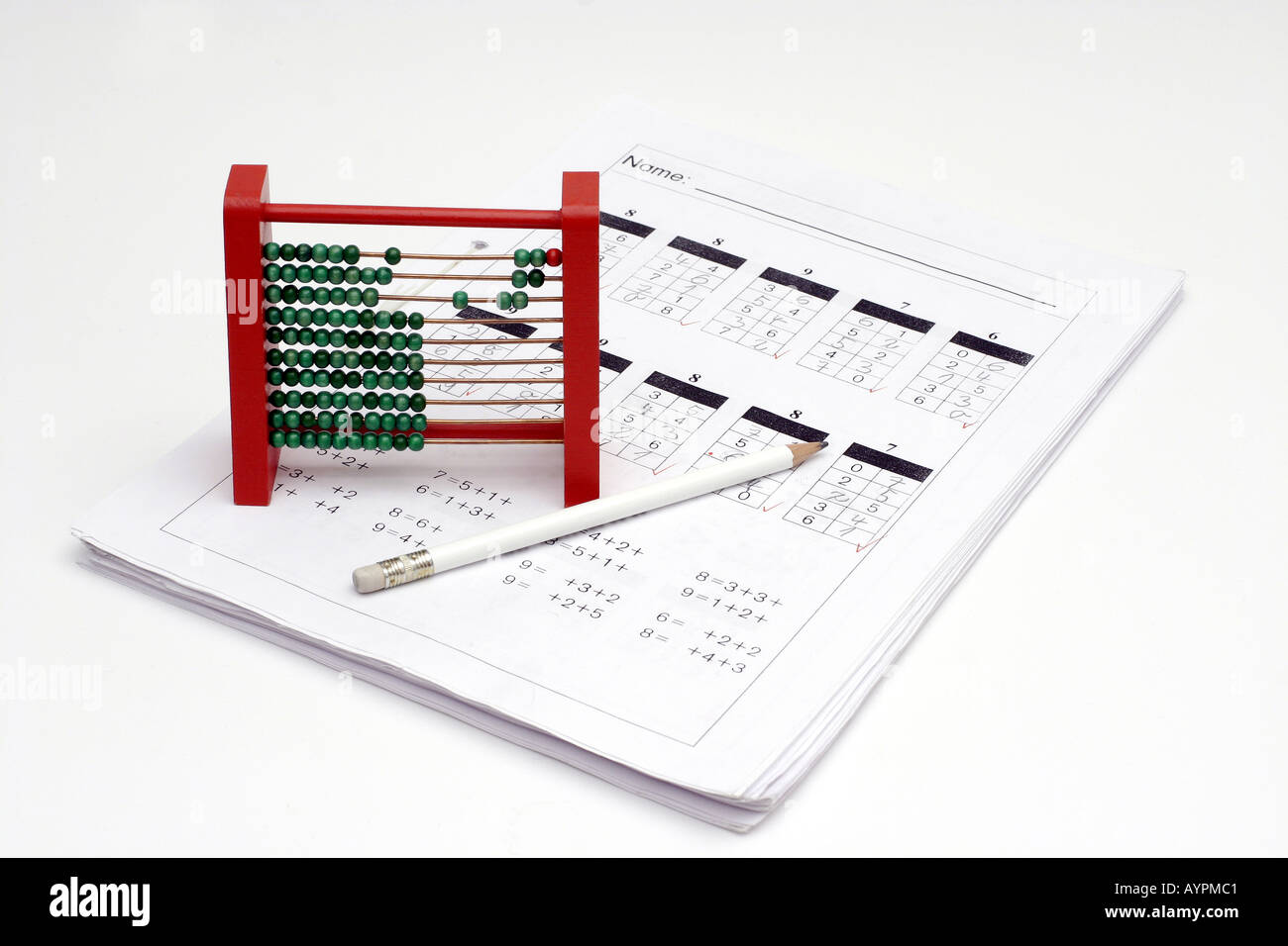 An abacus and a pencil is placed on the papers with mathematical equations written on it Stock Photo