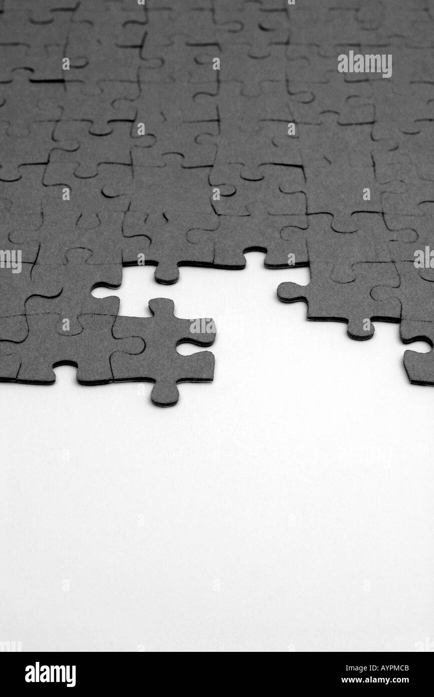 Small pieces of varied shapes of a puzzle are joined together in the