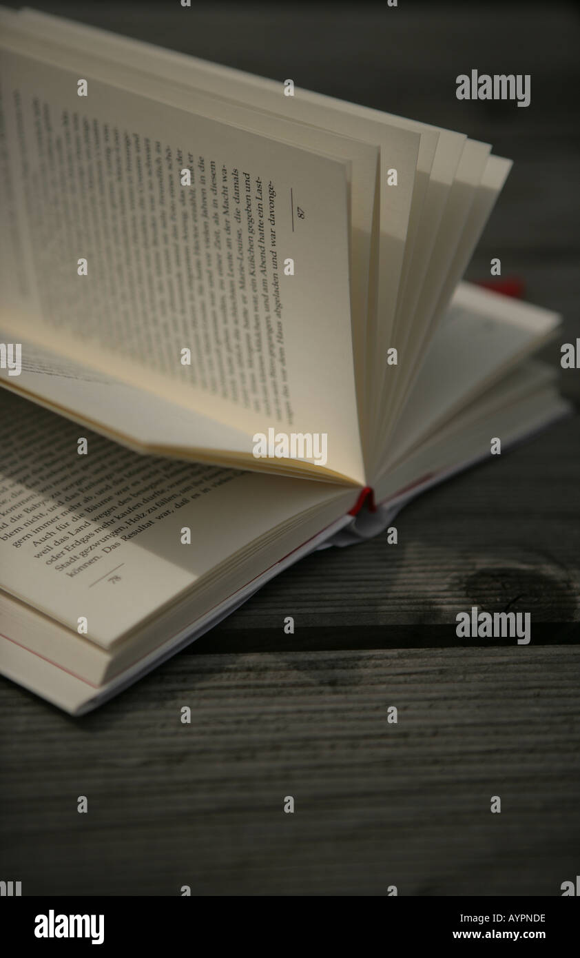 Close up of a novel placed on a wooden table Stock Photo