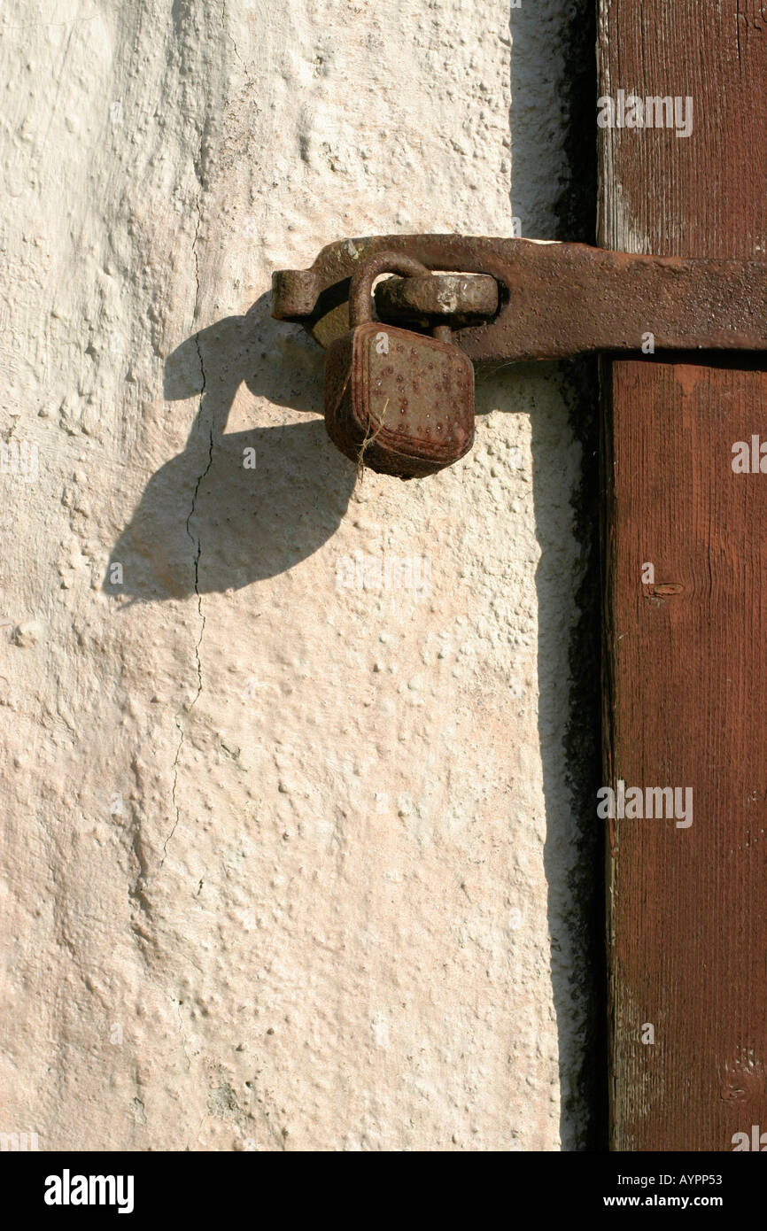 Front view of a locked latch beside the wall Stock Photo