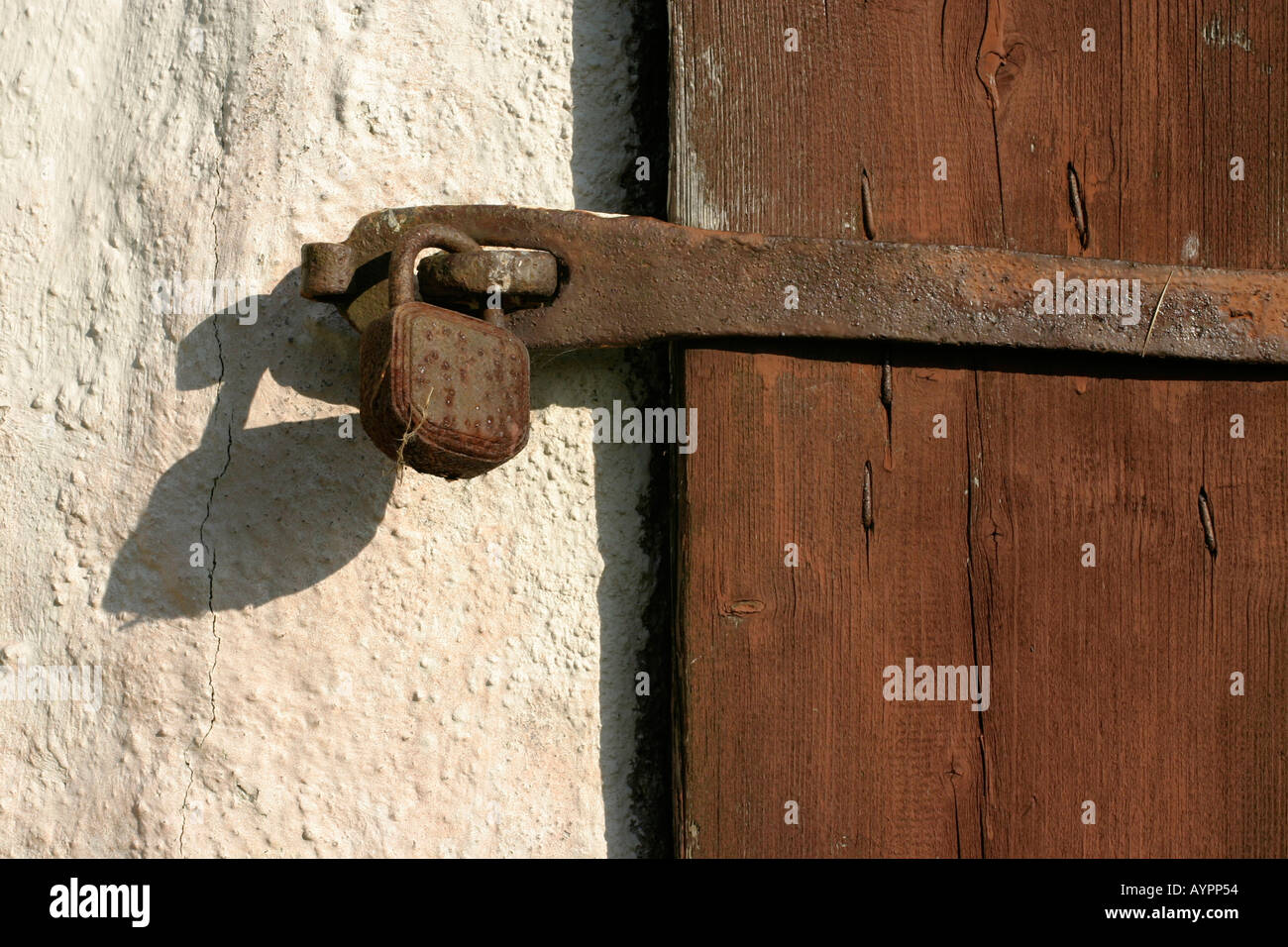 Front view of a locked latch beside the wall Stock Photo