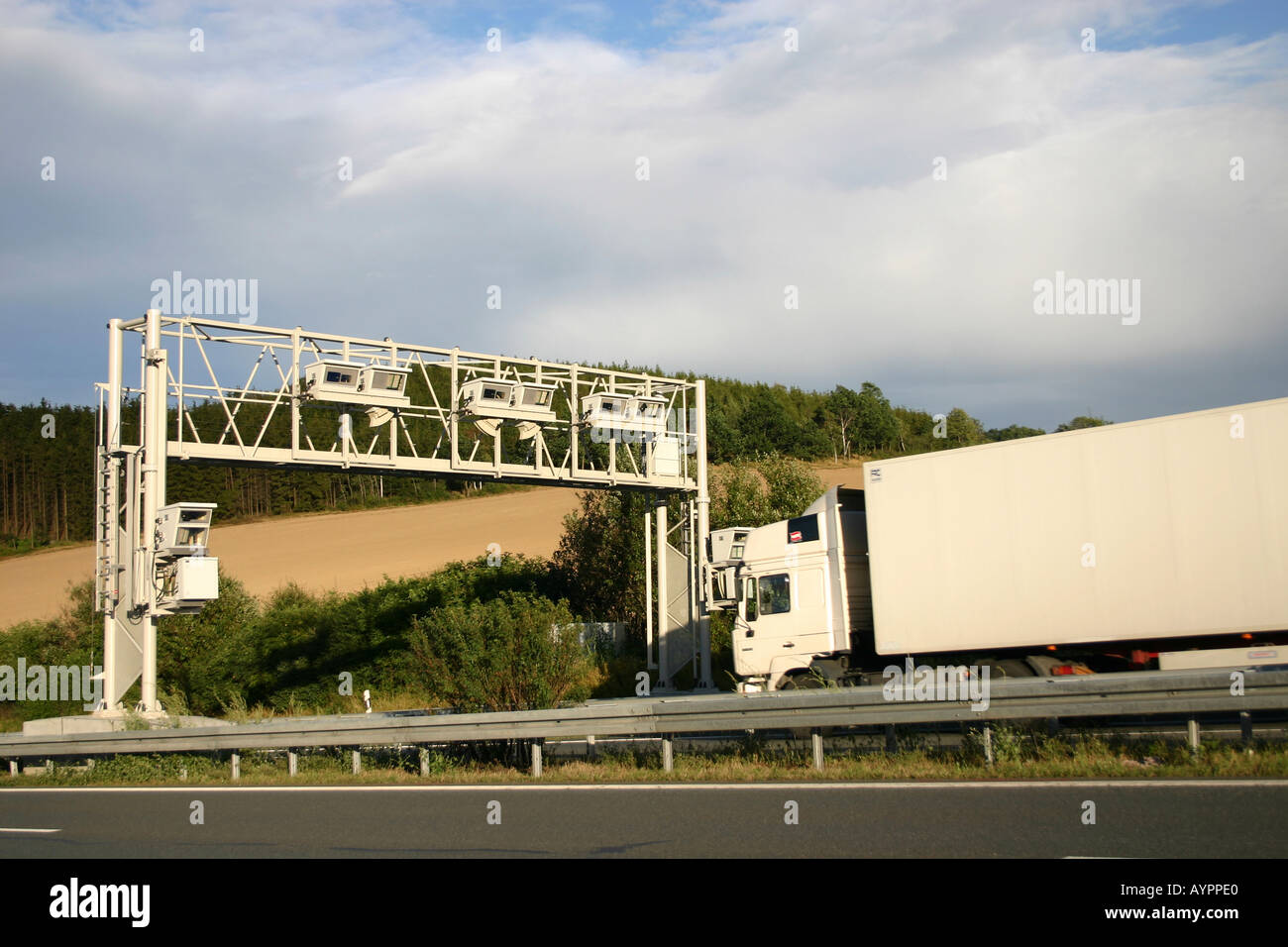 A truck seen near an overhead truss for registering the motorway toll Stock Photo