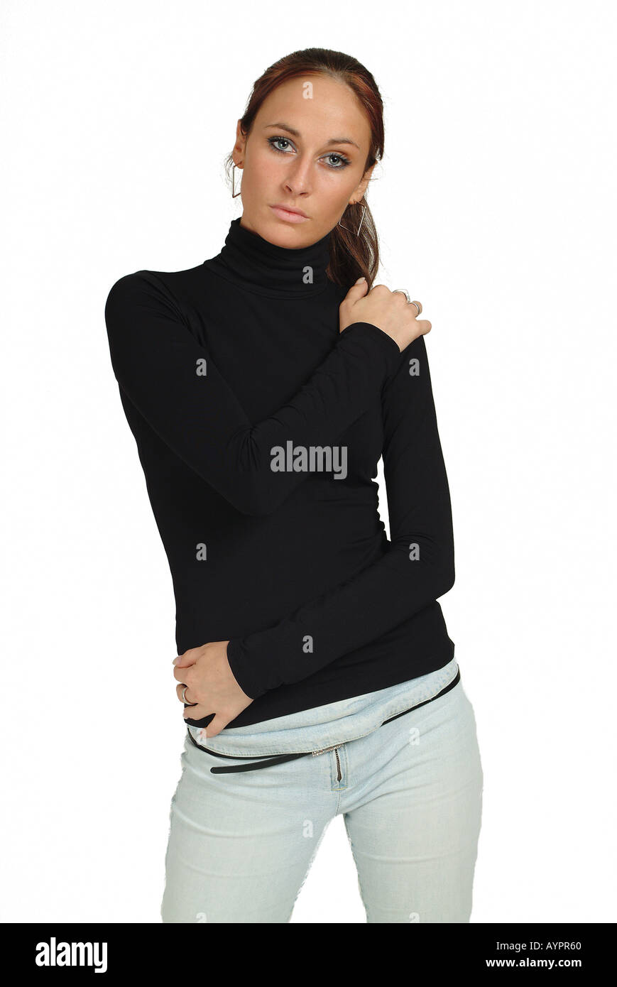 A young woman in full sleeves polo neck stares at the camera Stock Photo