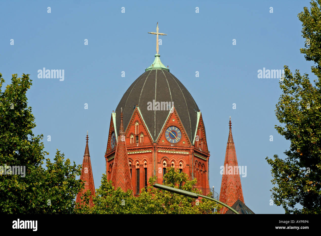 top cross on top of red brick church Stock Photo