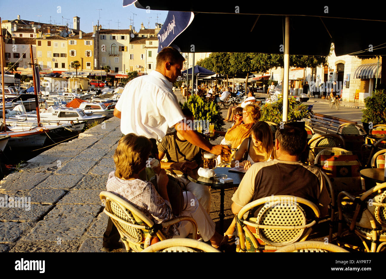 People relaxing in a harbourside cafe bar in Rovinj Stock Photo - Alamy