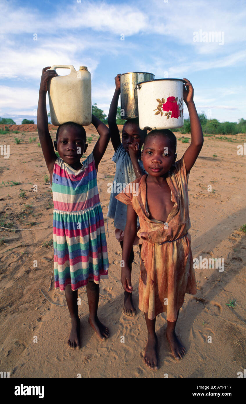 Young Girls From The Batonga Tribe Carrying Water Home On Their Heads Stock Photo Alamy
