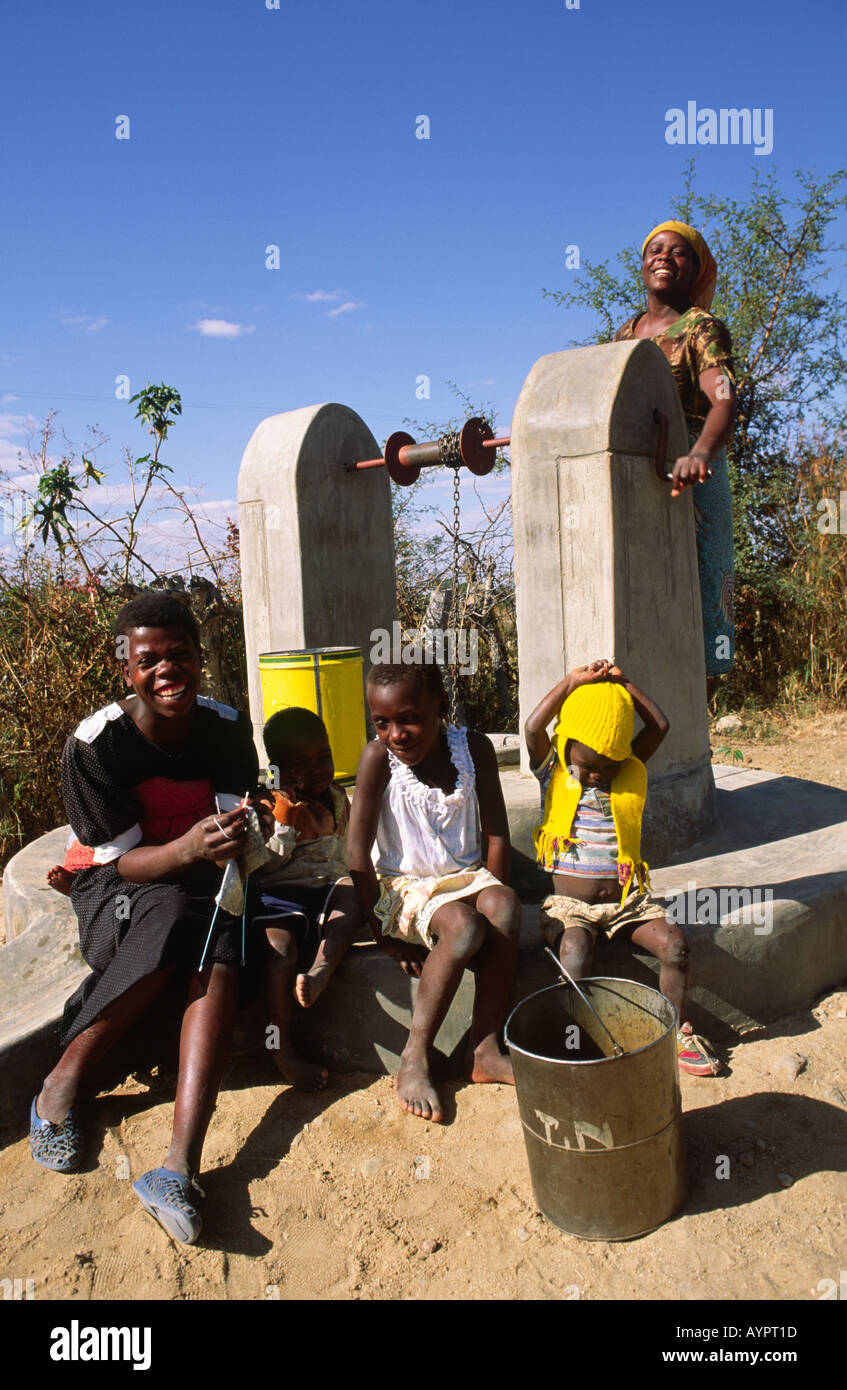 Family using a new community bucket and chain well. Zimbabwe Stock