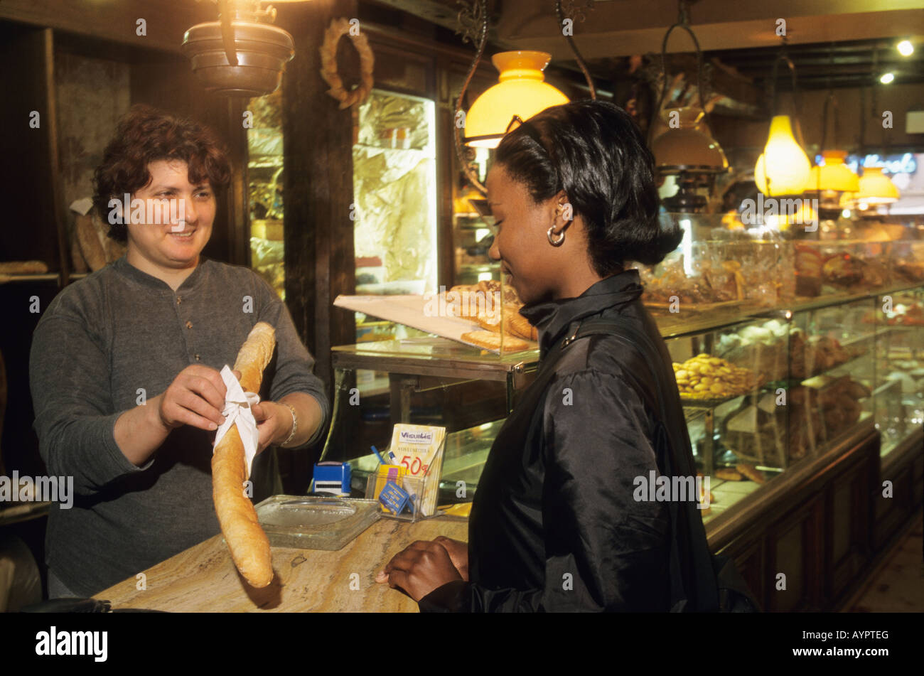 Teen buys bread in bakery, Paris France Stock Photo