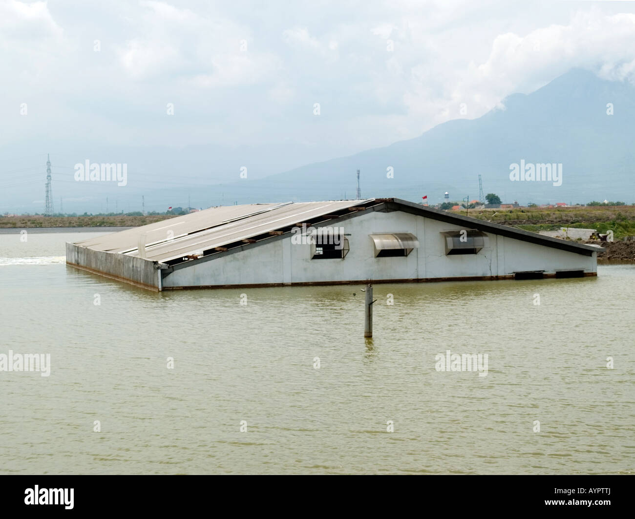 Top of a factory sticking out of lake of hot water and bubbling gas,Sidoarjo,East Java,Indonesia. Stock Photo