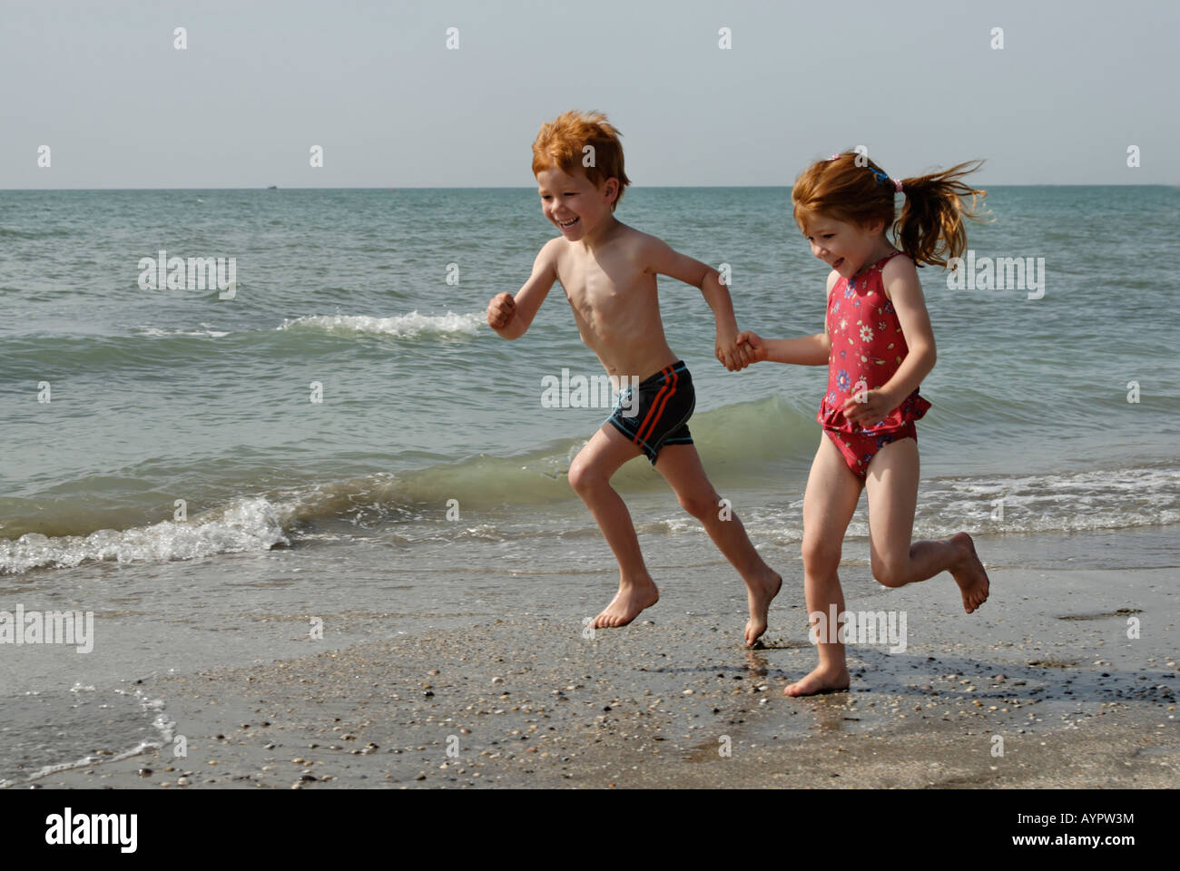 Two Children Running On The Beach Stock Photo Alamy