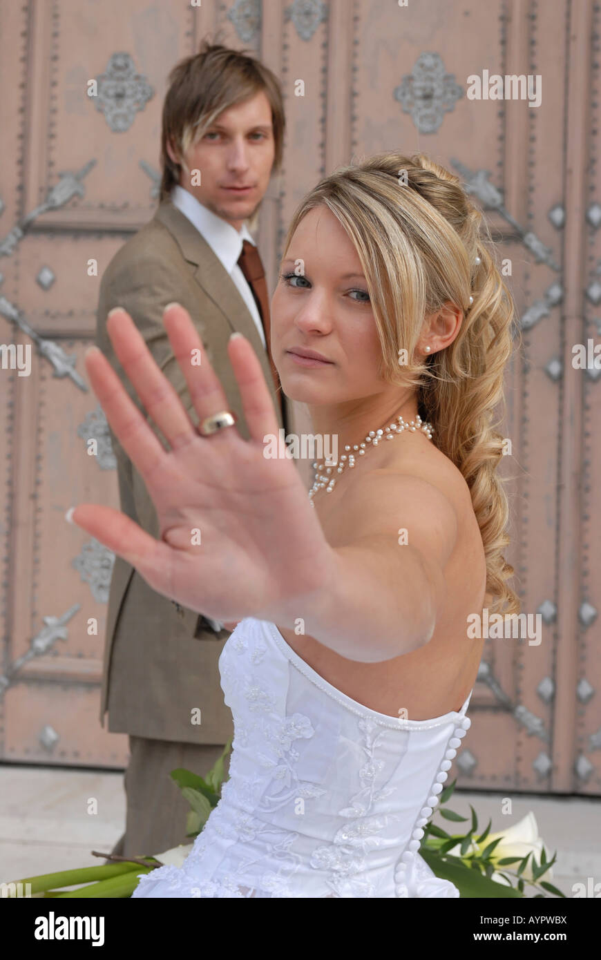 Bride and groom, wedding couple on church steps, gesturing no photographs, no paparazzi Stock Photo
