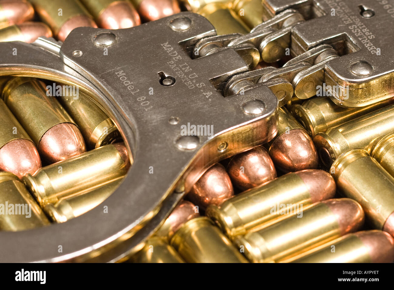 Handcuffs on top of .45 caliber ammunition Stock Photo