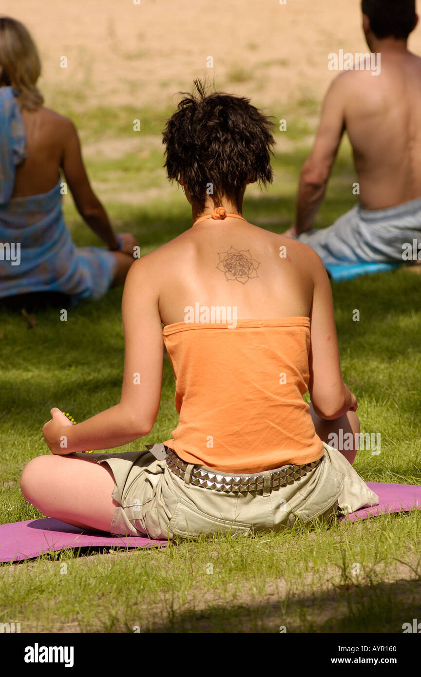 A 20 25 years old white western buddhist female meditating on the coast of lake in Kuchary Buddhist center Poland Stock Photo