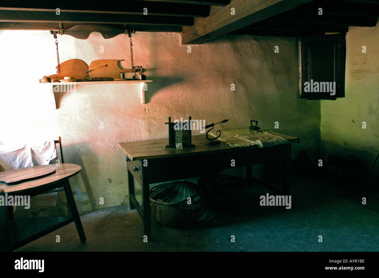 Interior of traditional Welsh cottage room at Museum of Welsh Life, St Fagans, Cardiff, South Wales, featuring rustic furniture and historic decor. Stock Photo