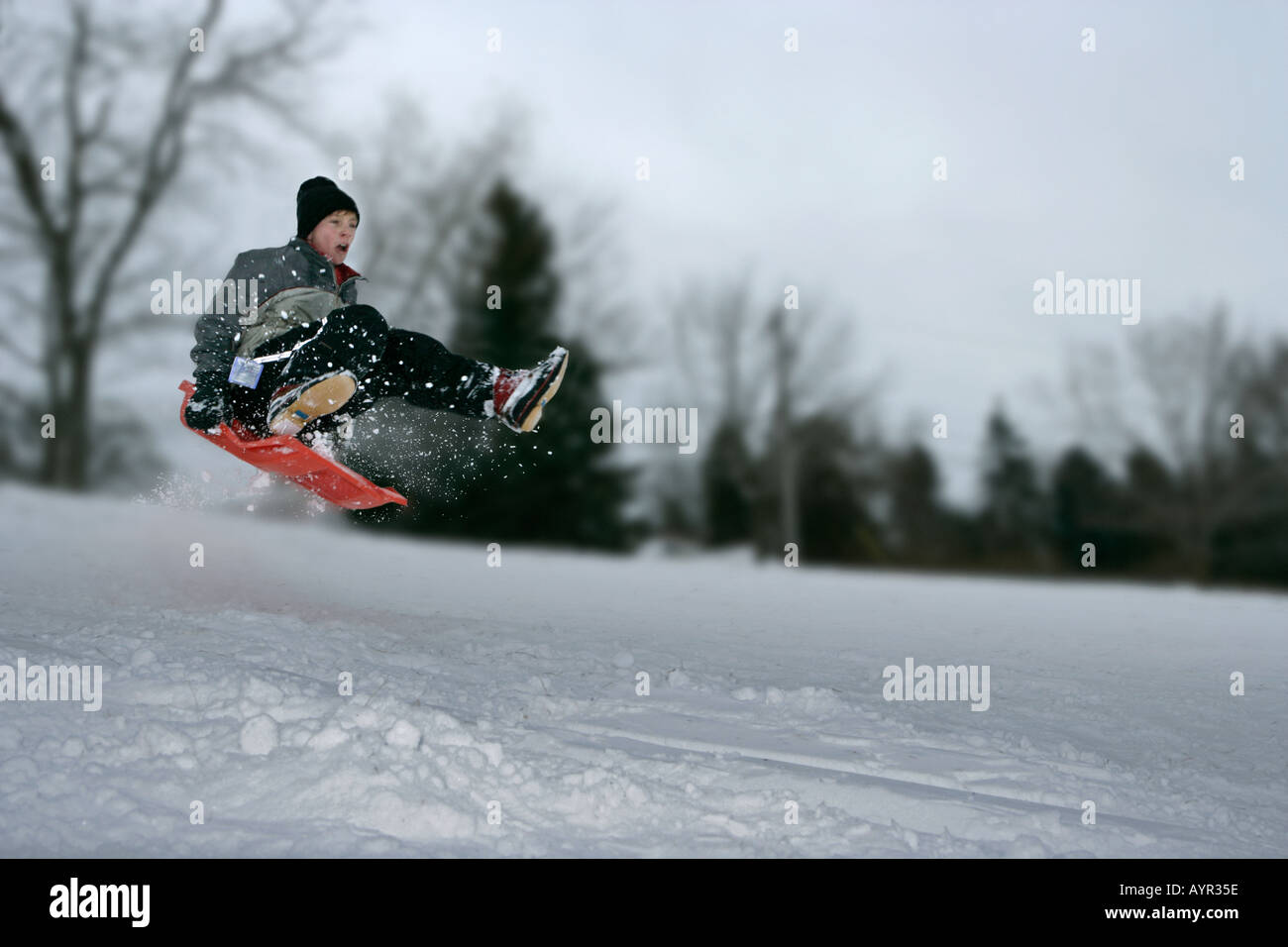 A 13 year old boy flies through the air after taking a jump while