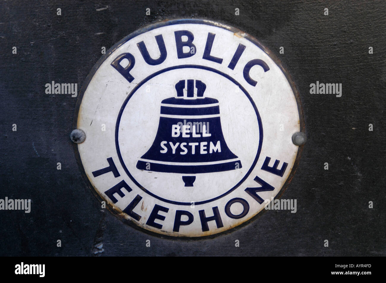 A sign advertising a public telephone pre dates the break up of AT T into baby bells  Stock Photo