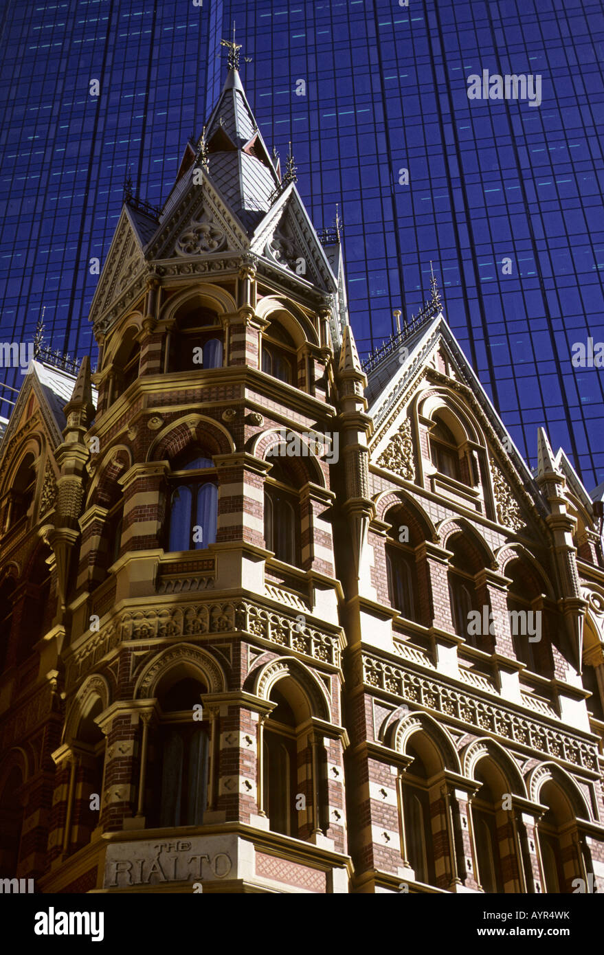 The Rialto Hotel in front of the glass facade of the Rialto Towers in Melbourne, Victoria, Australia Stock Photo