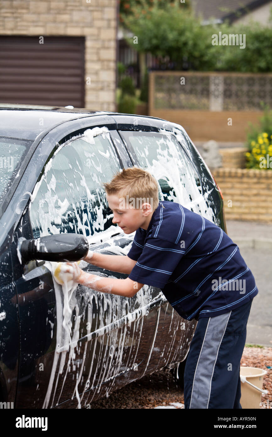 Young boy washing parents car Stock Photo Alamy