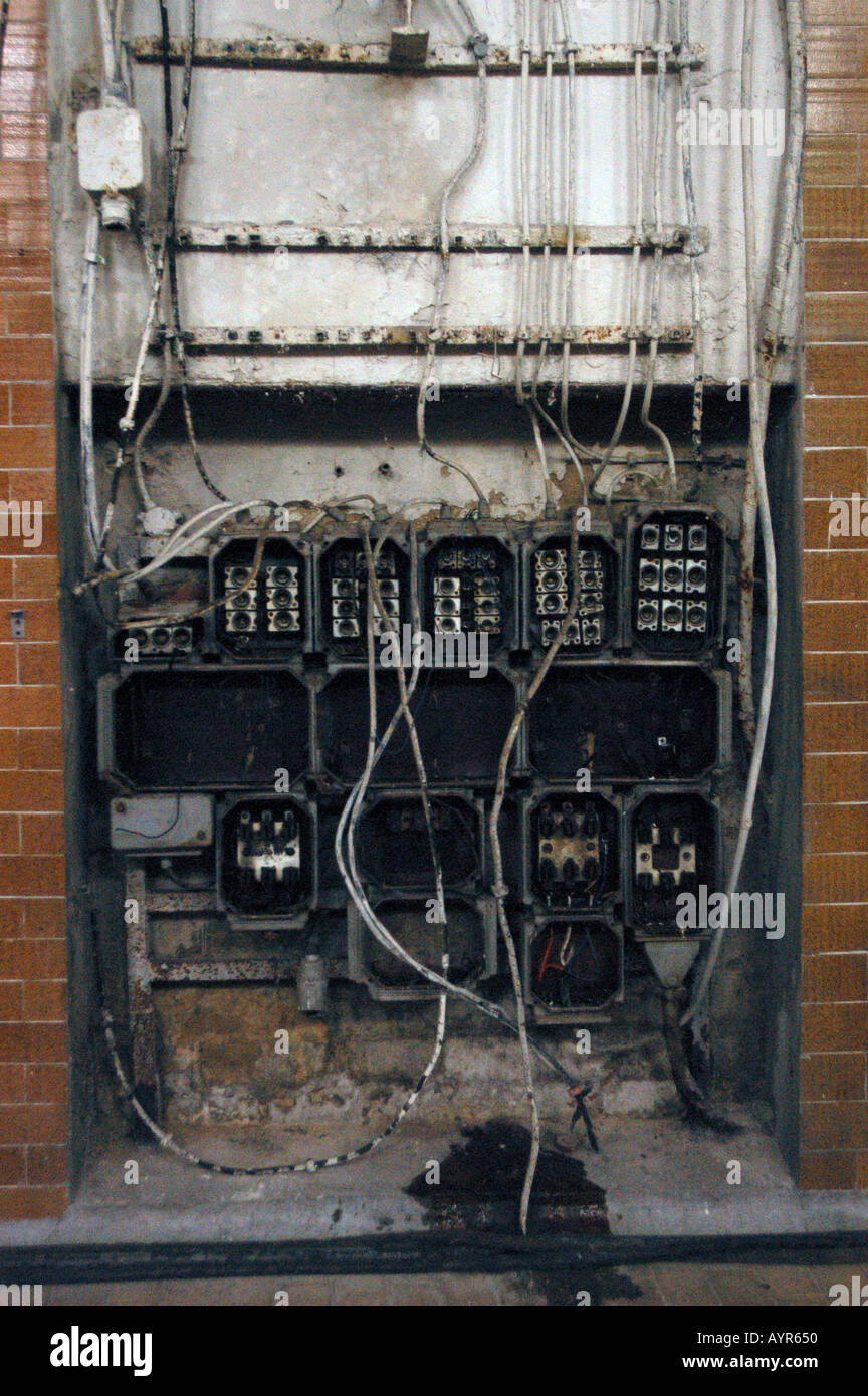 Badly destroyed electric facility with exposed wiring and broken ...