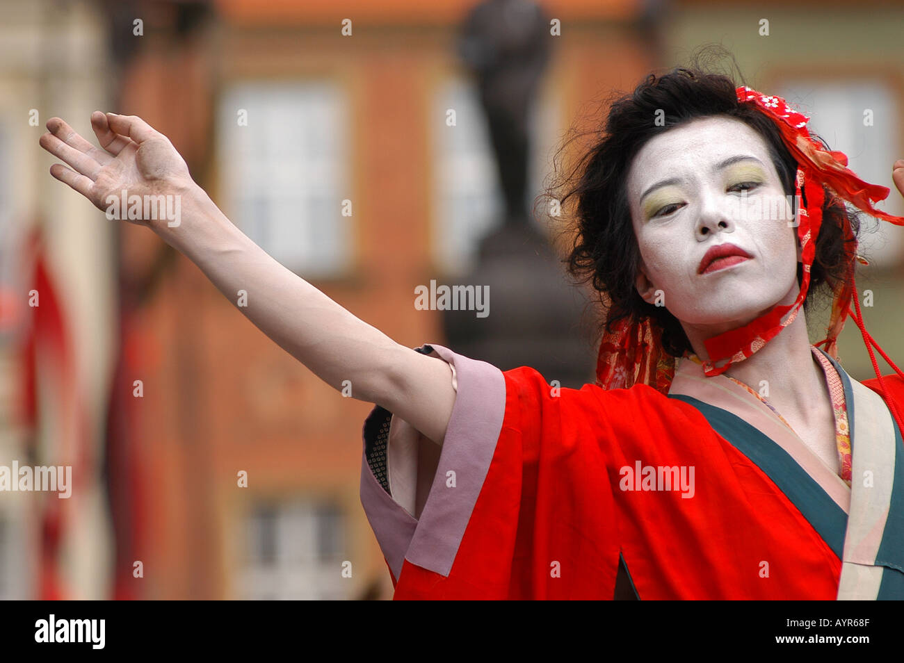 Japanese female dancer performing traditional Butoh dance open air