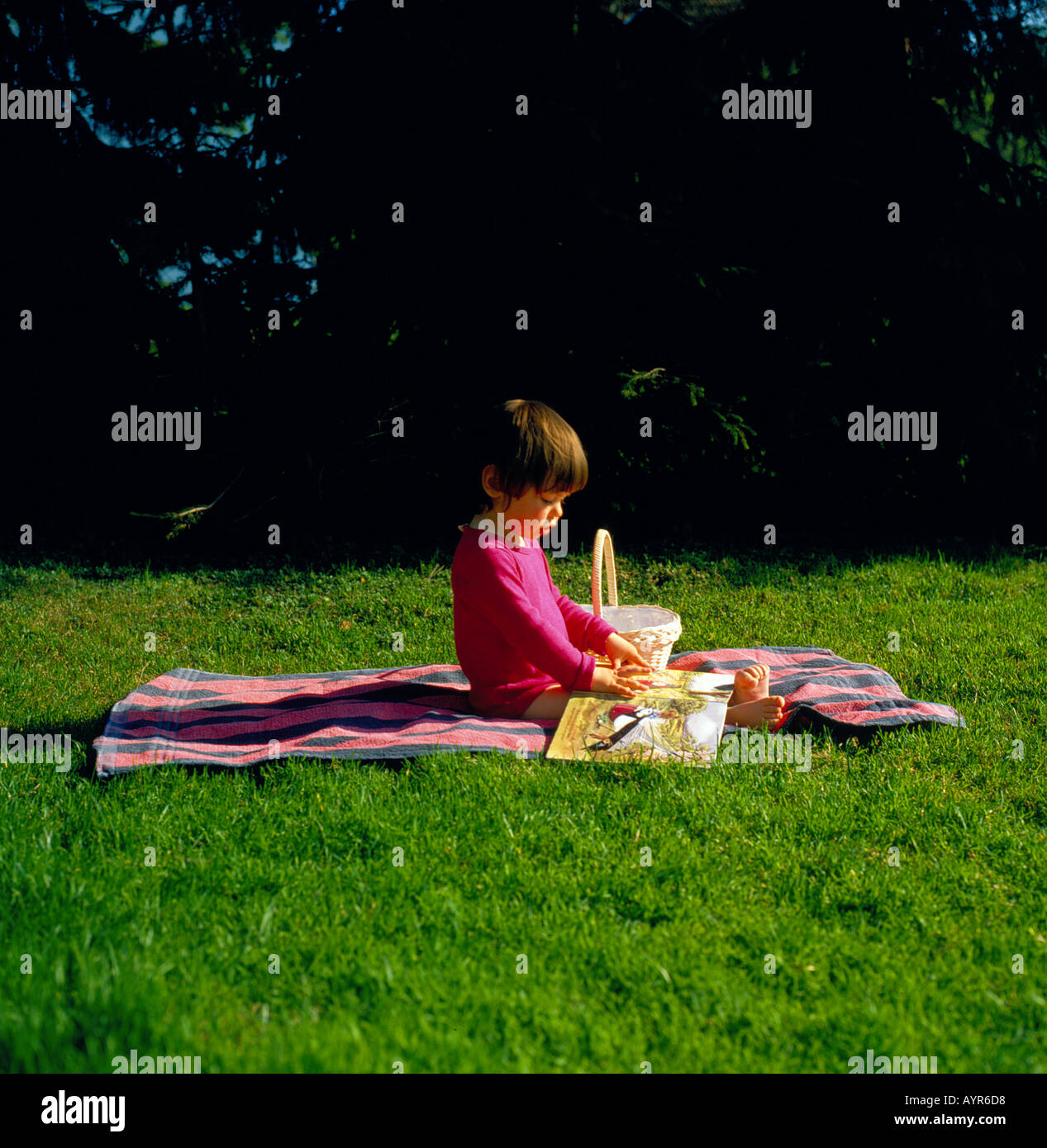 little girl looking at childrens book. Photo by Willy Matheisl Stock Photo