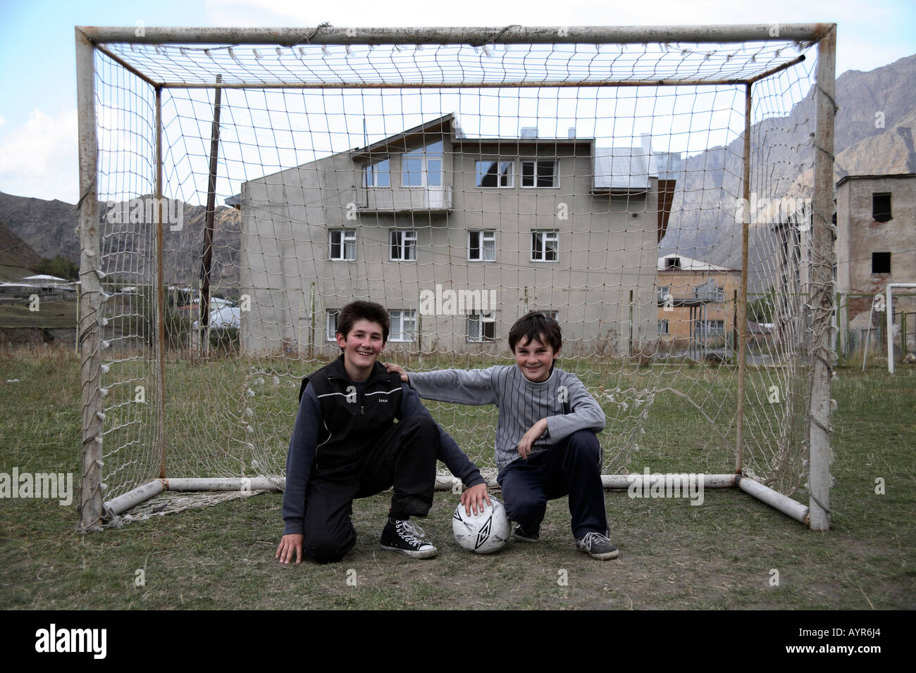Two young football playing boys posing in goal mouth. Kazbek, Georgia Stock Photo