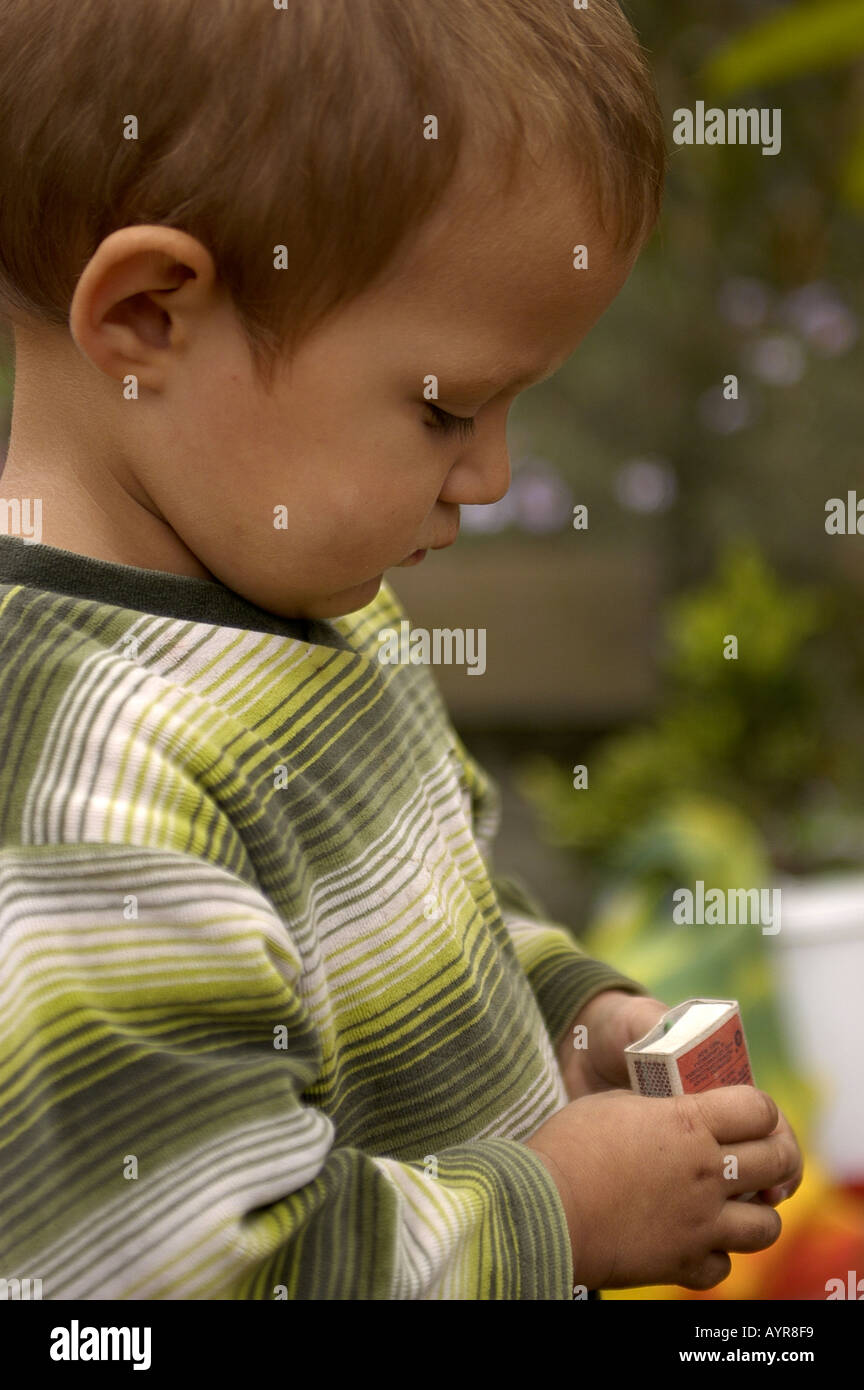 2 Years Old boy playing with matches Stock Photo