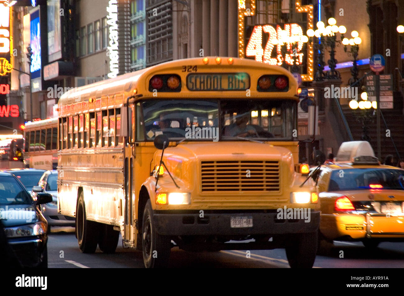 OLD SCHOOL BUS PASSING THROUGH 42ND STREET THEATER DISTRICT