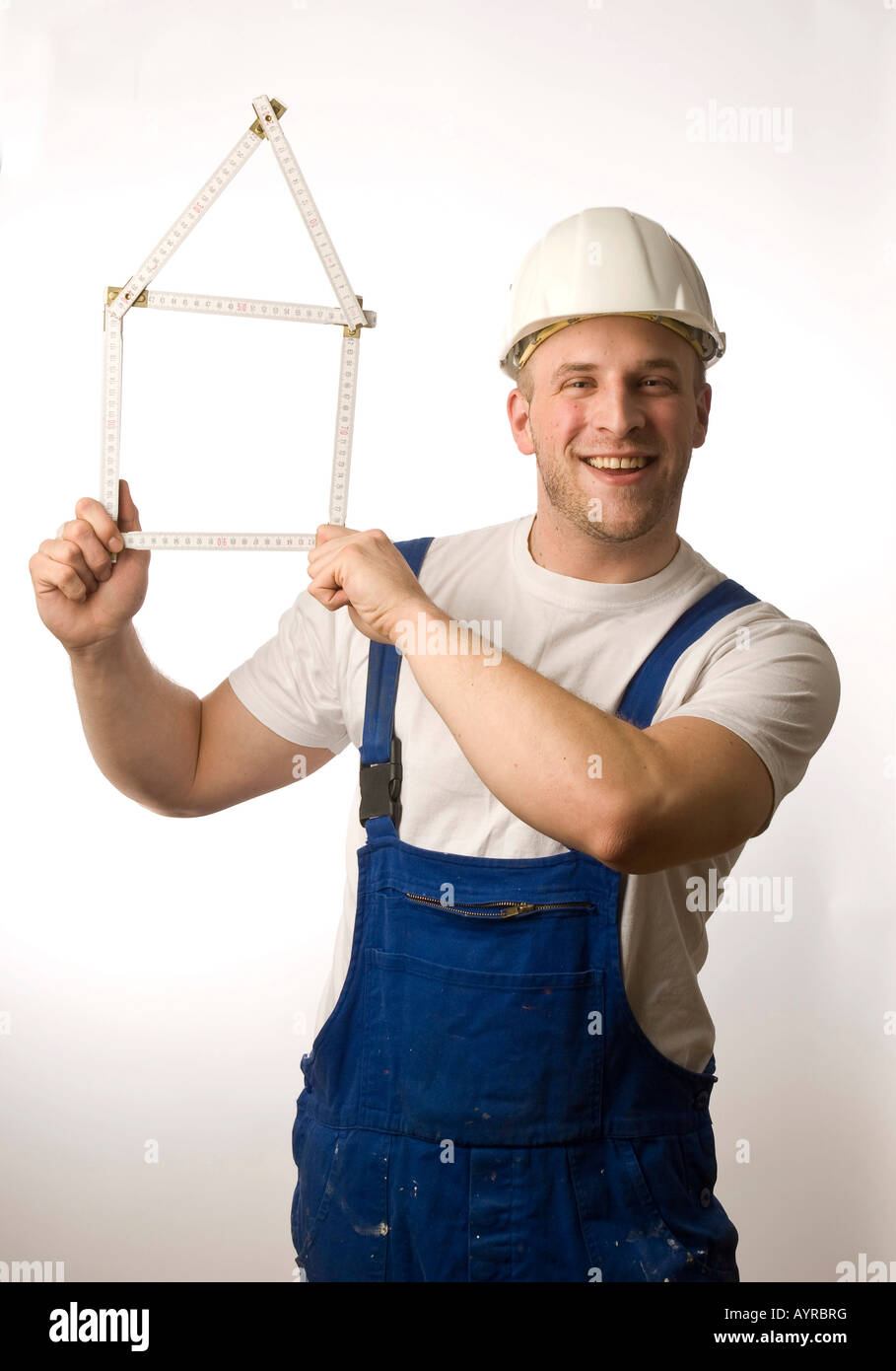 Construction worker holding folding rule (yardstick Stock Photo Alamy
