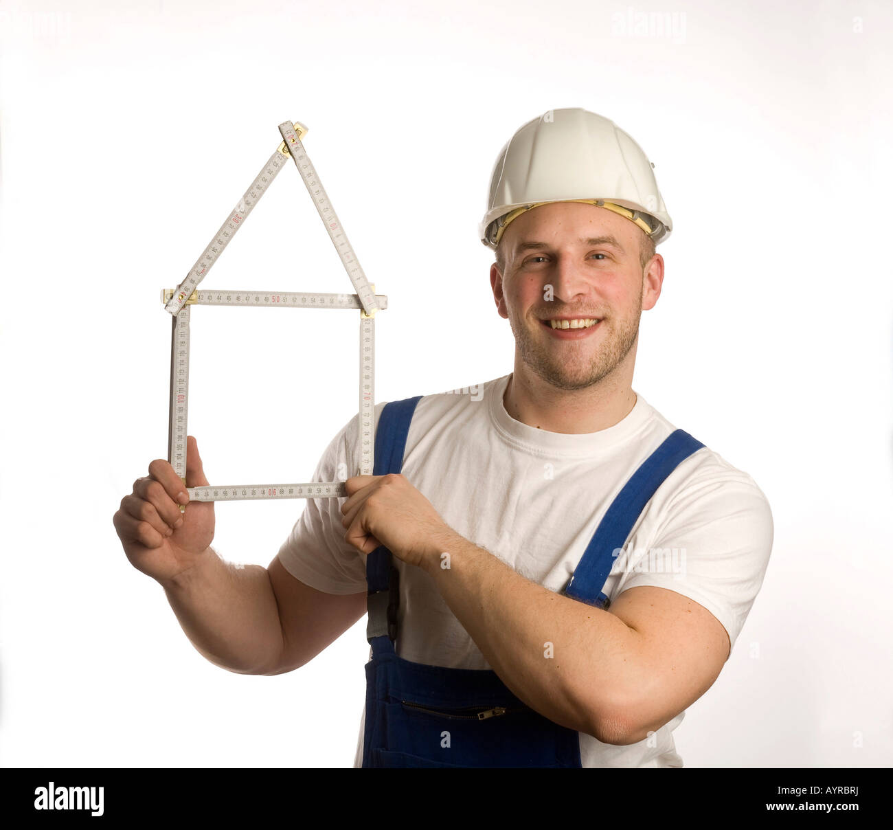 Construction worker holding folding rule (yardstick Stock Photo Alamy