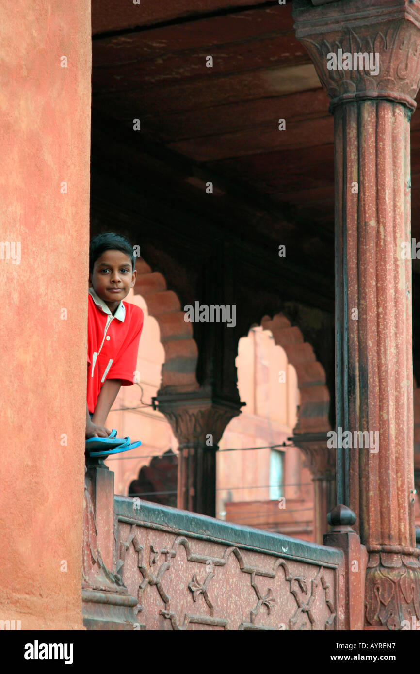 A curios kid appearing from the Jama Masjid mosque, Delhi, India Stock Photo