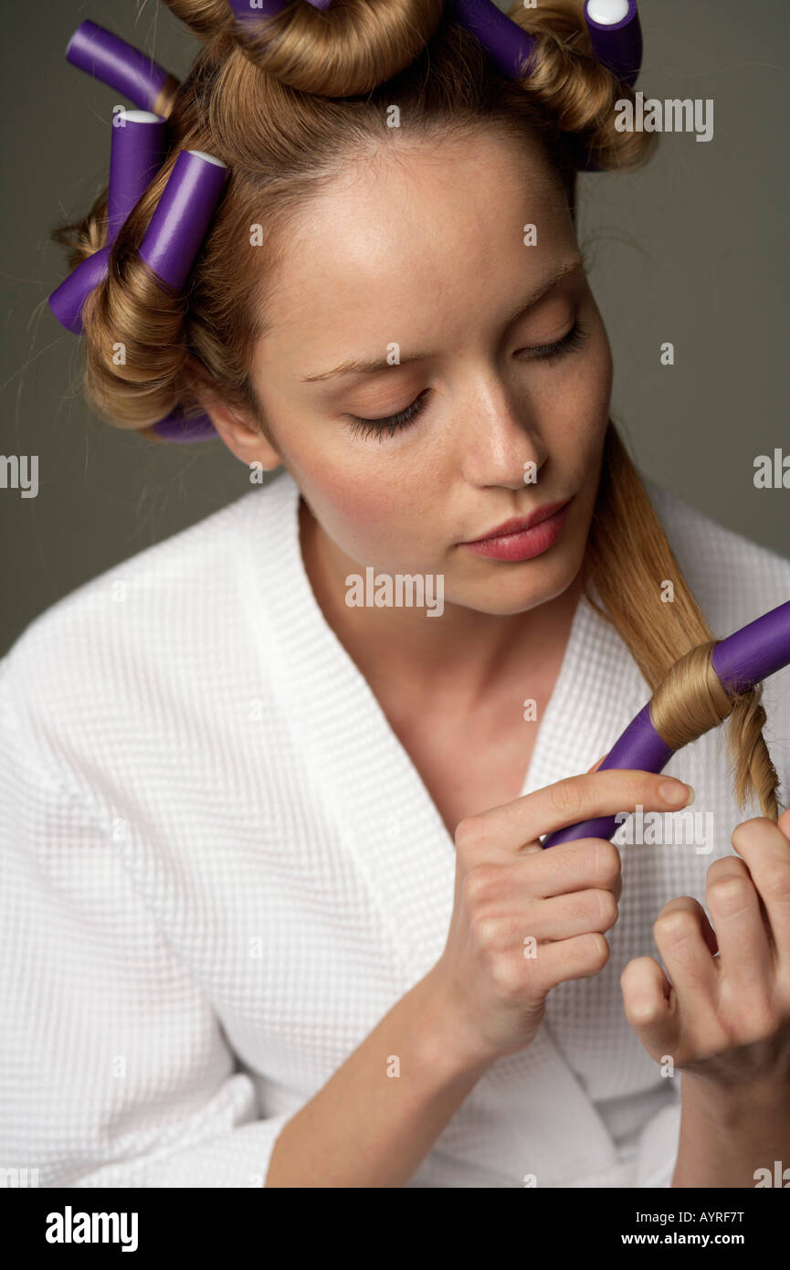 Young woman rolling hair in curlers Stock Photo Alamy