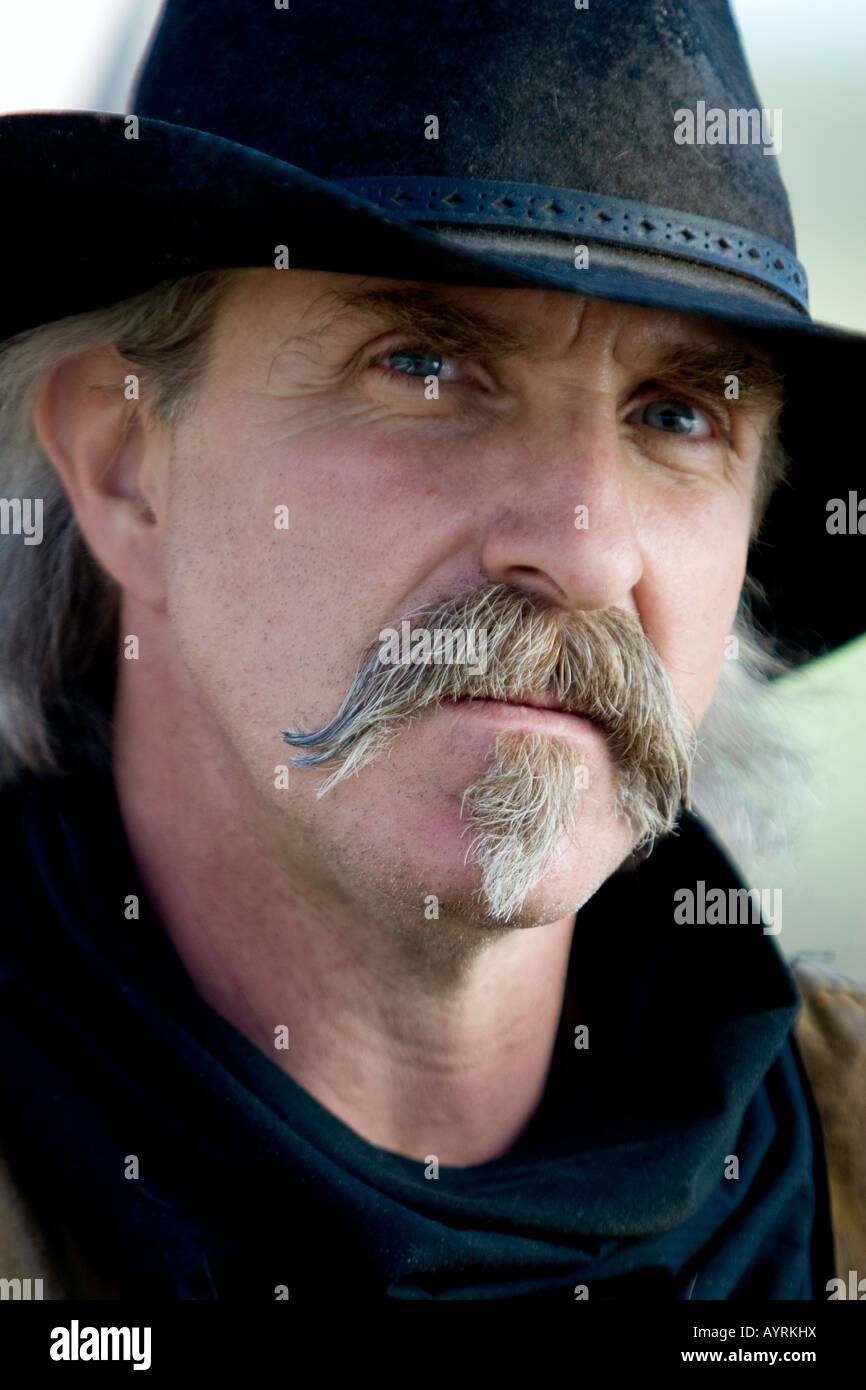A working cowboy on a ranch in colorado in a hat and bandanna Stock Photo
