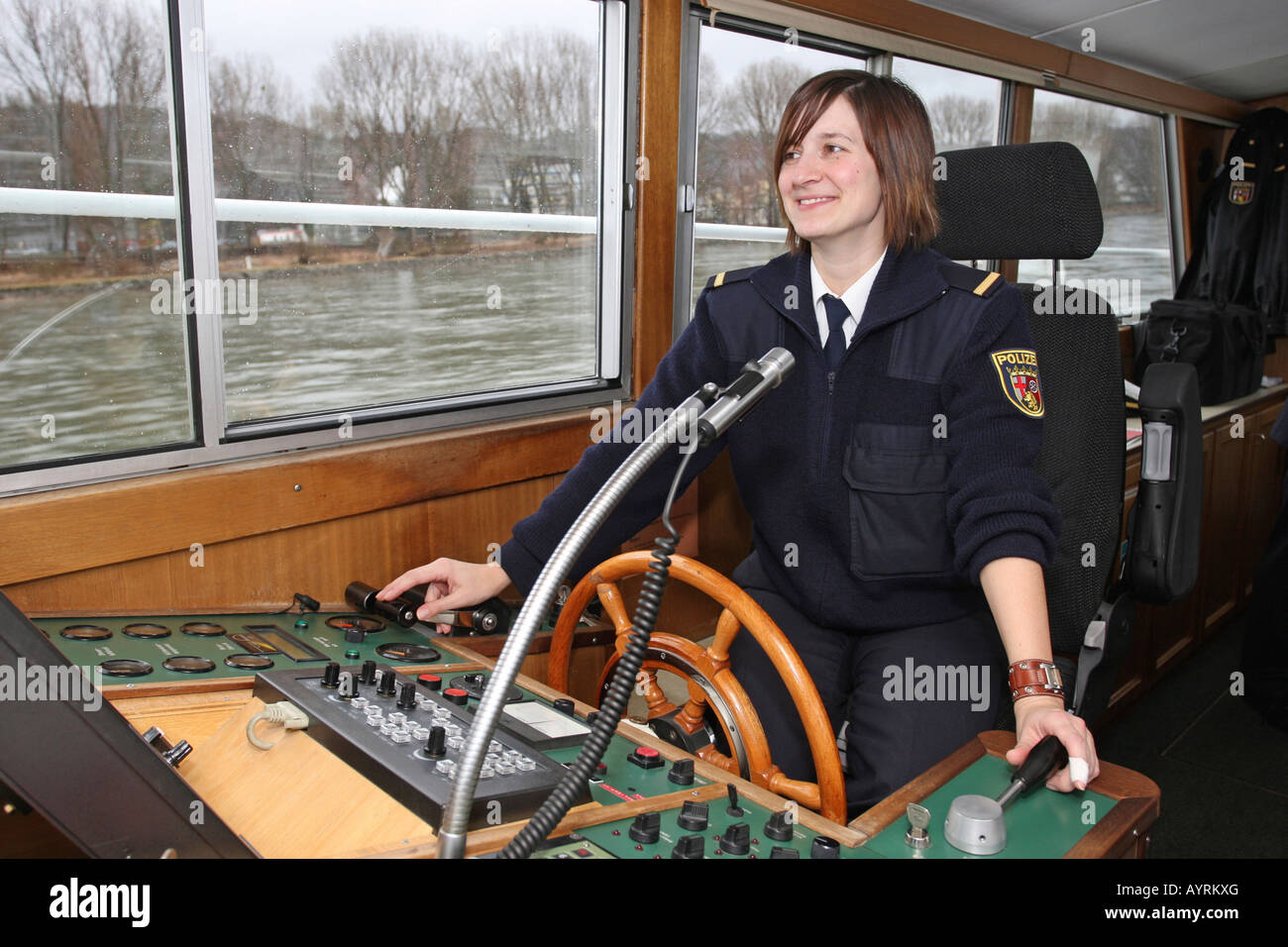 Police commissioner Katrin Pletsch at the wheel of the WSP 11 police boat on the Rhine River near Koblenz, Rhineland-Palatinate Stock Photo