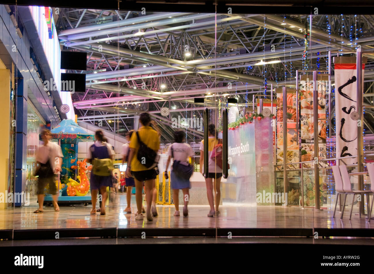 Shoppers at shopping mall in Singapore Stock Photo