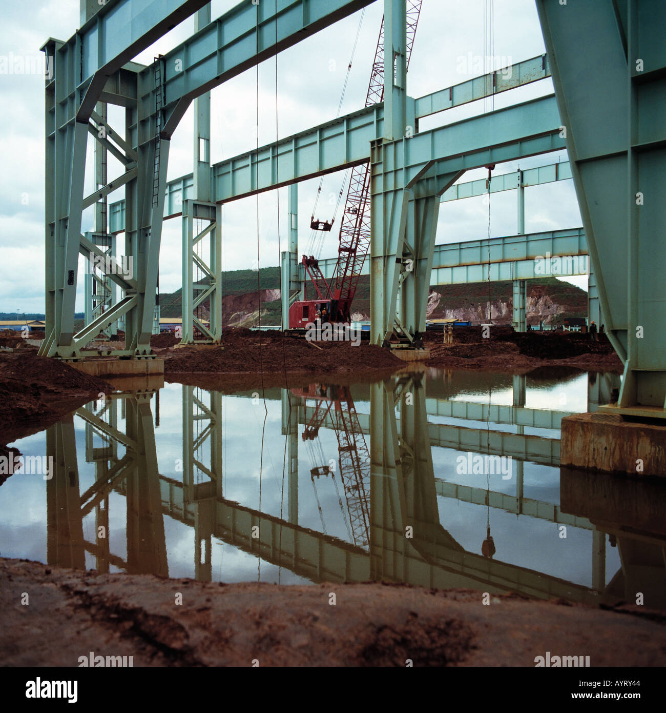building site, construction works, construction of a industrial hall, shell, steel structure, pillars, prop up, shore up, support, industry, industrial building, flooded building site, reflection on the water surface, mirror image, Brazil Stock Photo