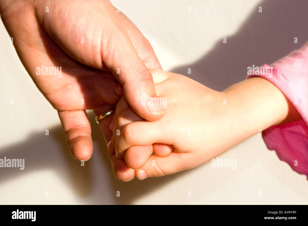 Father holding his daughter's hand Stock Photo