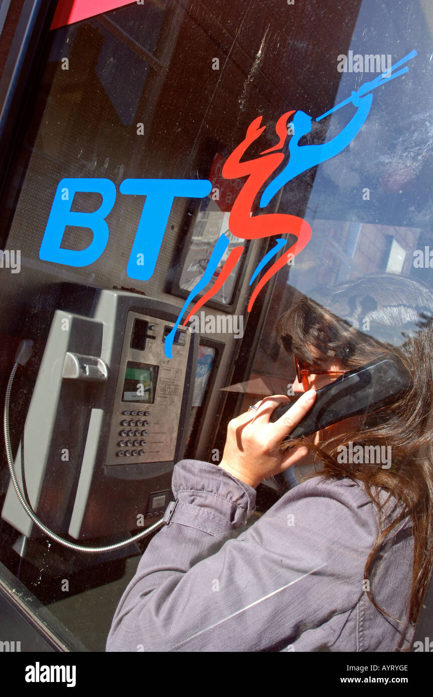 BT telephone box or booth, woman using British phone box, Britain UK Stock Photo Alamy
