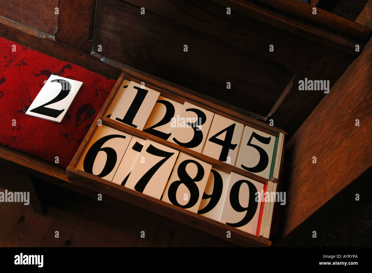 Hymn board numbers on a church bench Stock Photo