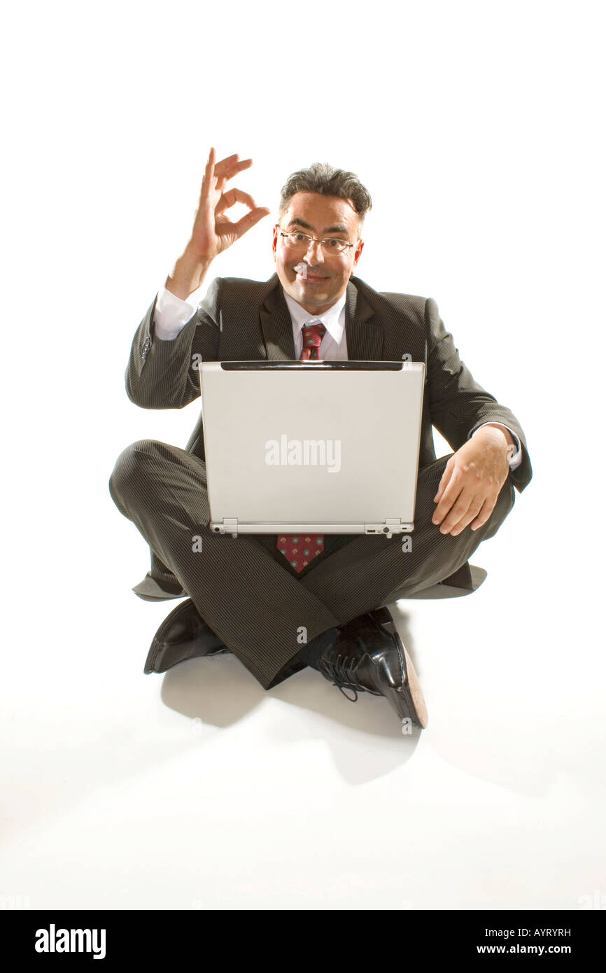 Businessman with a notebook on his lap - everything okay Stock Photo