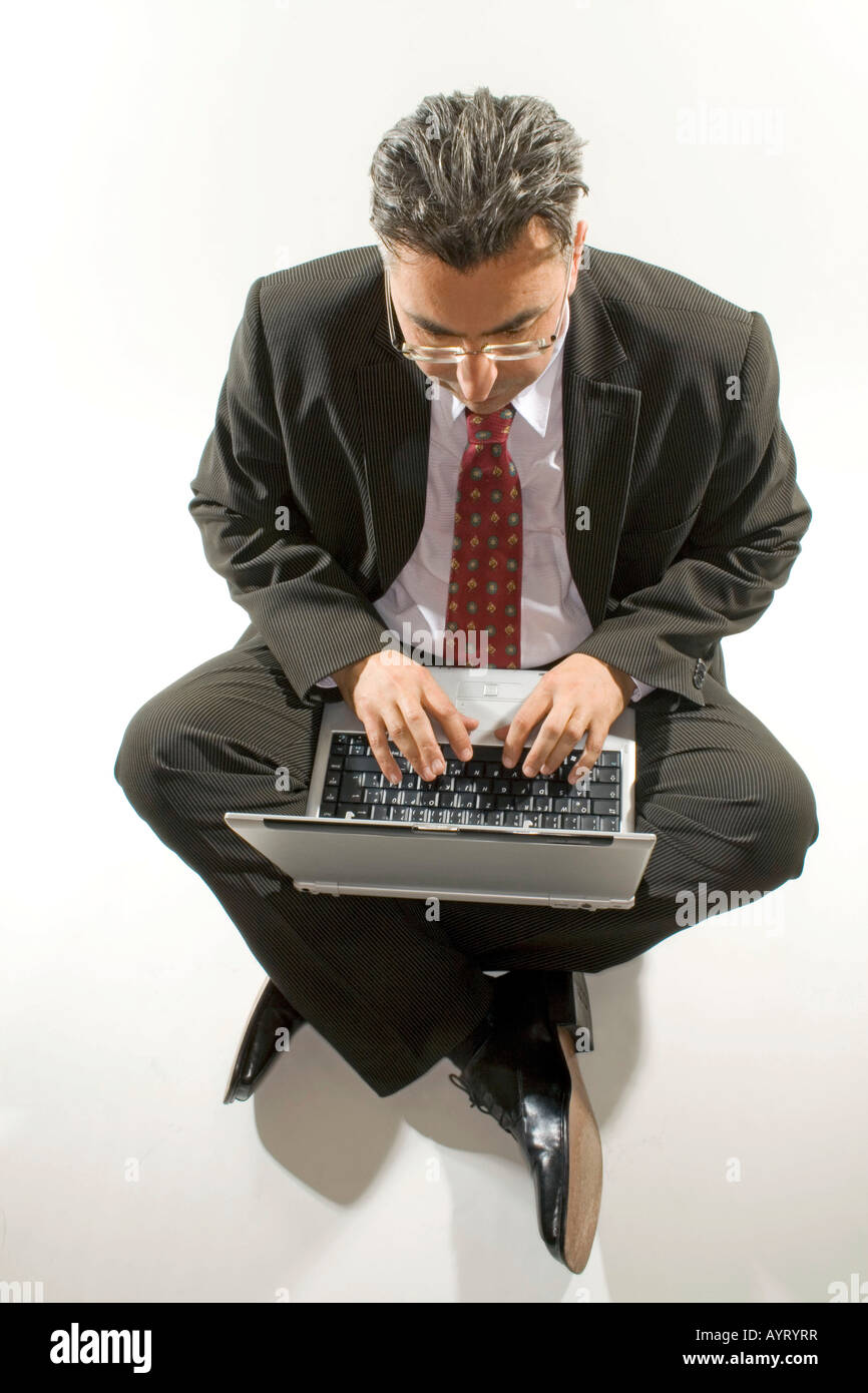 Businessman with a notebook on his lap Stock Photo