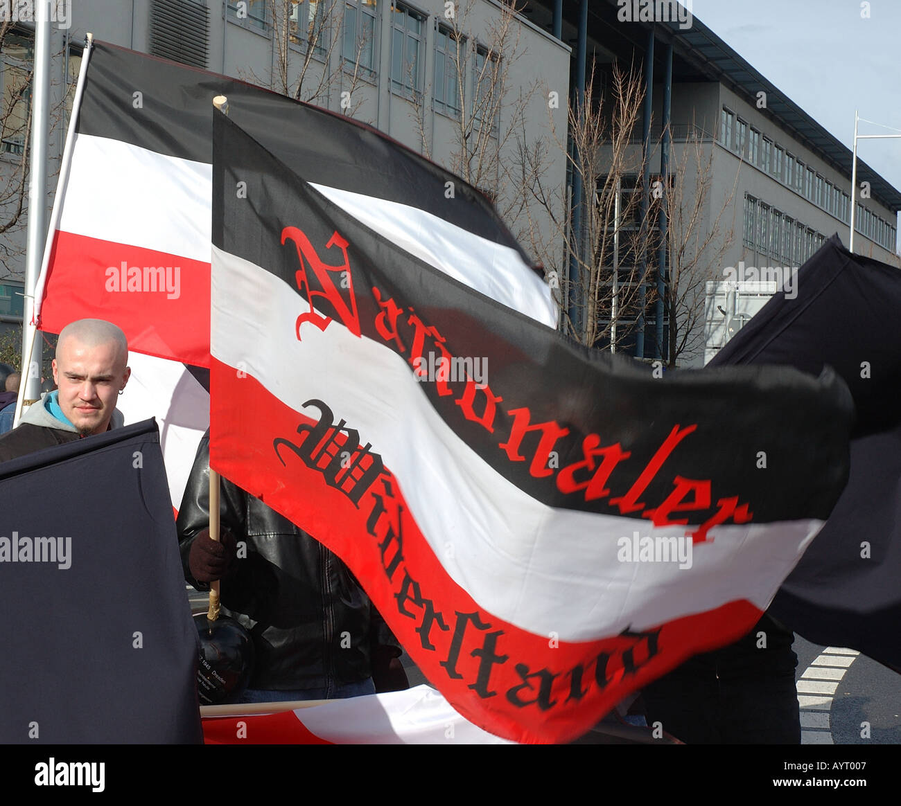 Far-right demonstrator flying flags at demonstration in Dresden Stock Photo