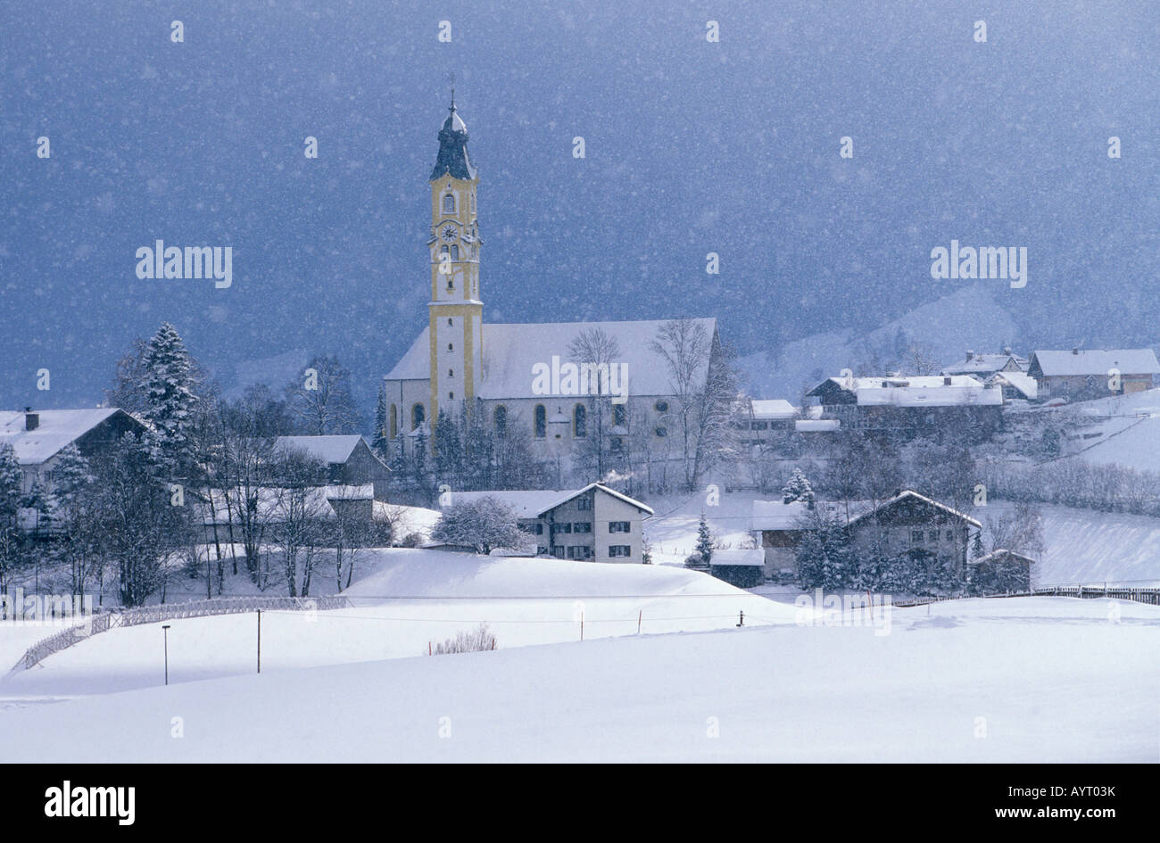 Snow falling over St. Nicholas Church, Pfronten, East Allgaeu, Bavaria, Germany, Europe Stock Photo